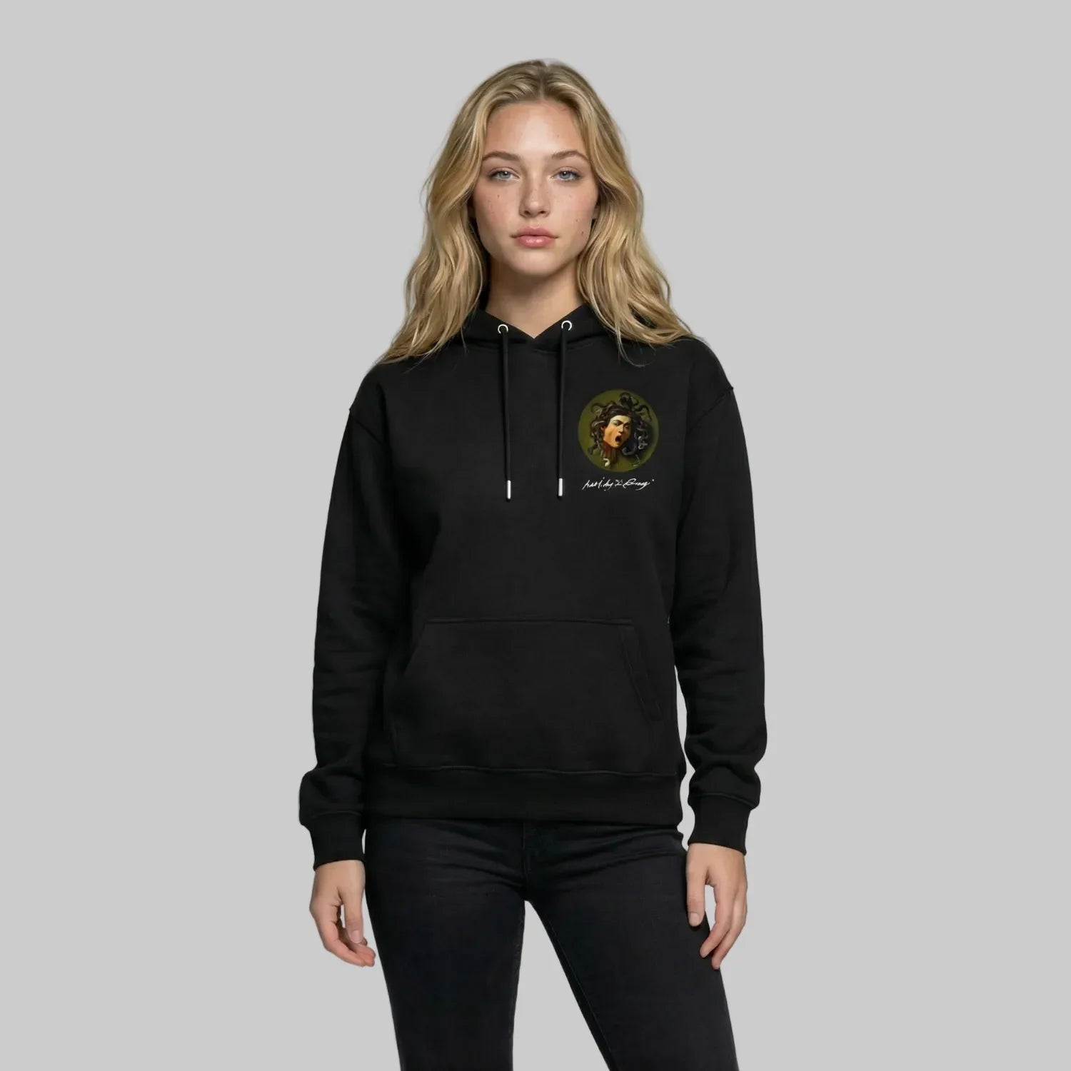 Person wearing a black hoodie with a logo on a plain background