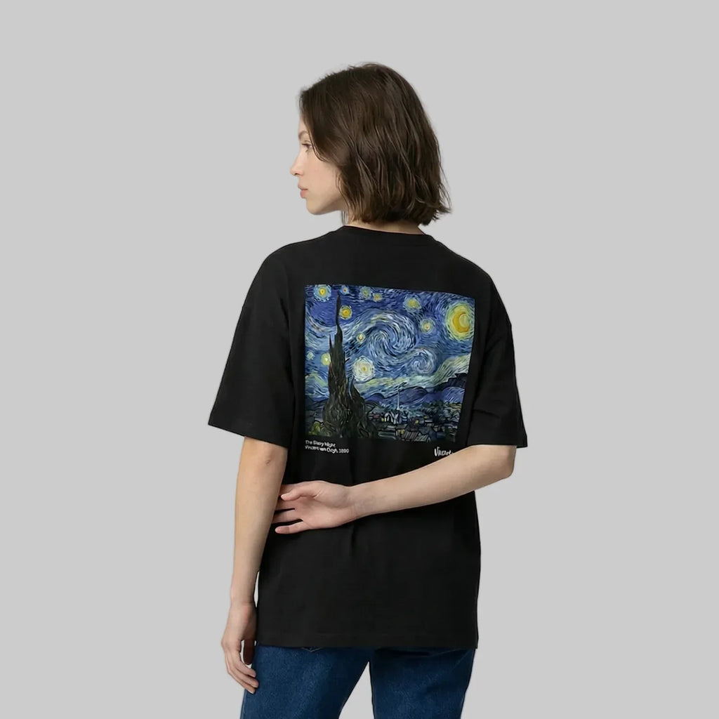 Person wearing a black t-shirt with a Van Gogh painting design on the back against a plain background